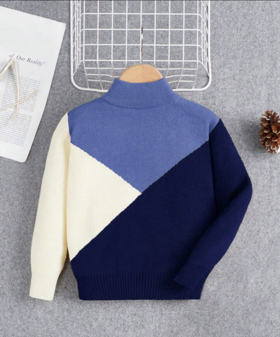 Blue knit sweater with white and navy designs