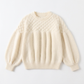 Front view of ivory white puff-sleeve knit sweater with diamond lattice yoke laid flat on white