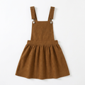 Front view of girls brown adjustable suspender corduroy dress laid flat on white