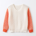 Front view of girls white mesh knit sweater with orange sleeves laid flat on white
