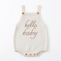 Front view of ivory Hello Baby knitted strap romper laid flat on white