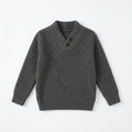 Dark grey knitted sweater with two neck buttons laid flat on white